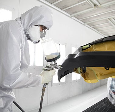 Collision Center Technician Painting a Vehicle | Madera Toyota in Madera CA