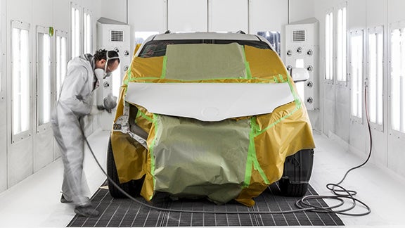 Collision Center Technician Painting a Vehicle | Madera Toyota in Madera CA